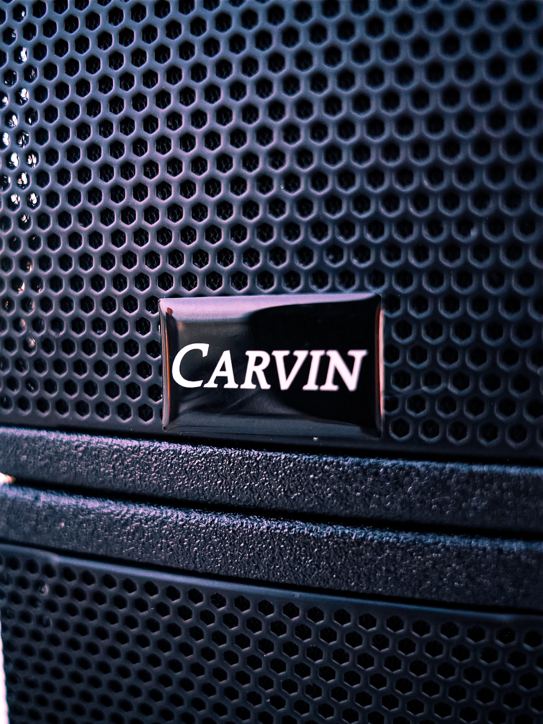 Close-up of the Carvin badge on the grille of a powered PA speaker