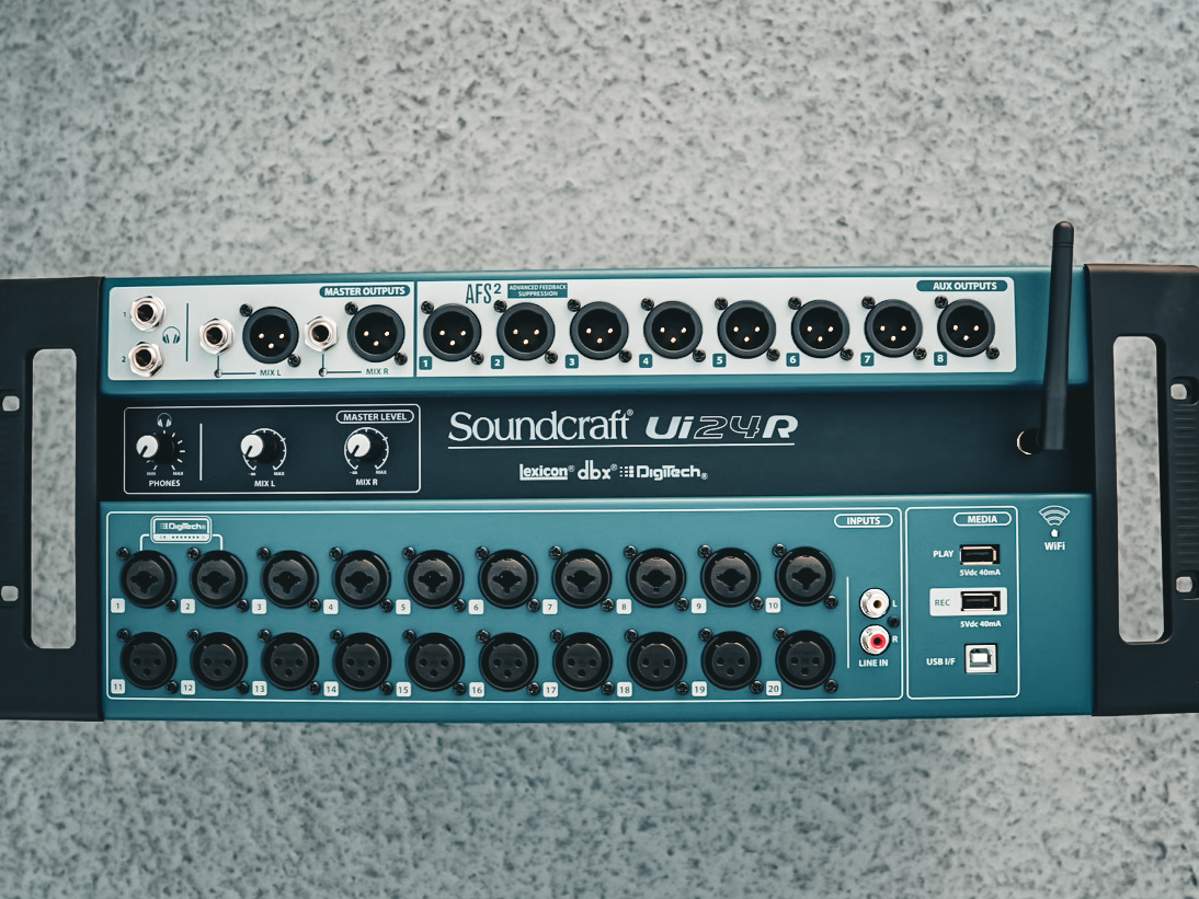Close-up of a Soundcraft Ui24R digital mixer showing its twenty microphone inputs and eight aux outputs