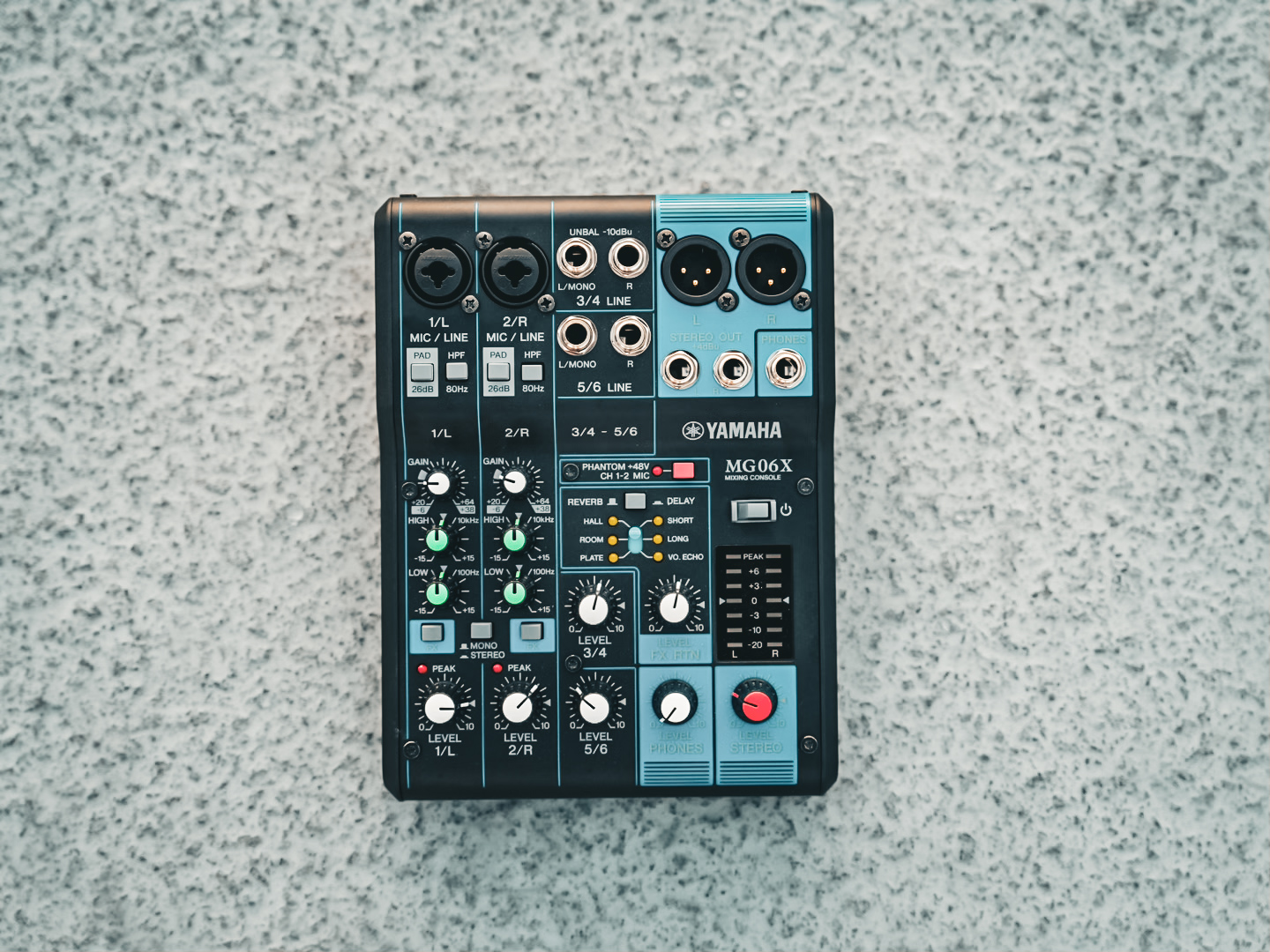 A Yamaha MG06X mixer on pavement before being packed for an event