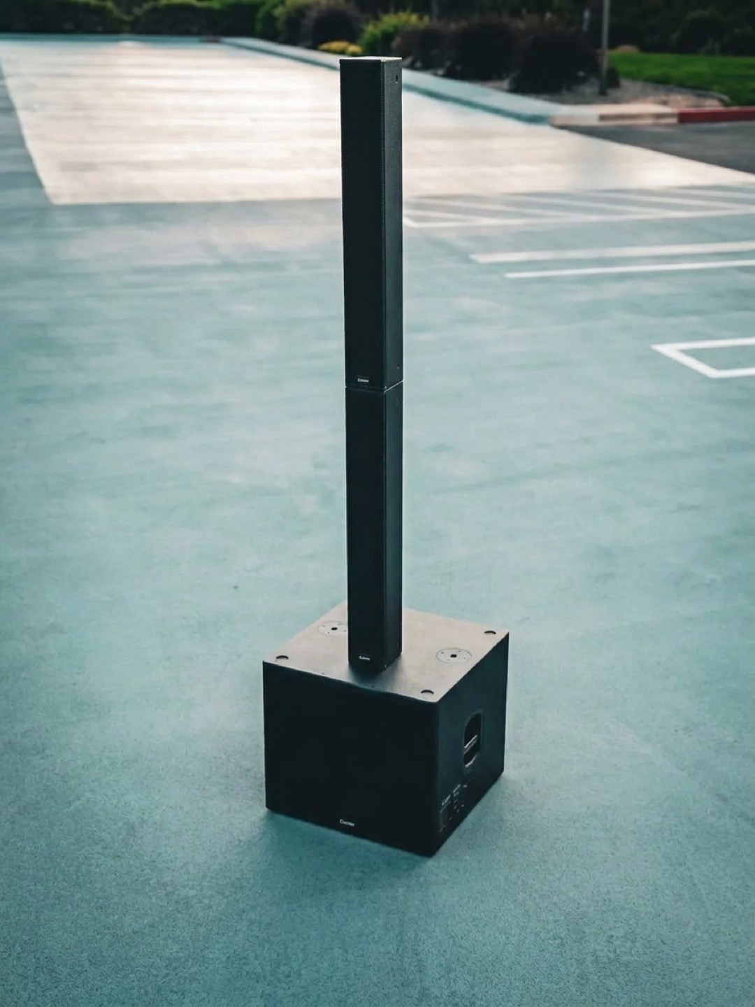 Two column array sections stacked directly on a single subwoofer, the whole system standing in one compact footprint