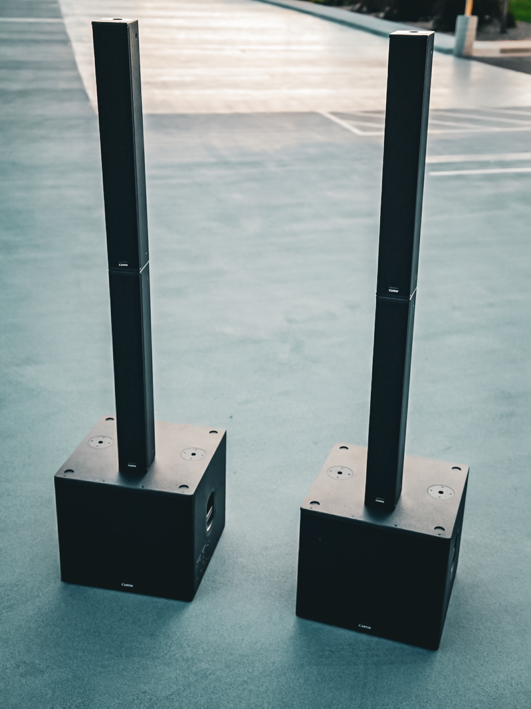 A pair of column array speakers stacked on subwoofers for full-range coverage