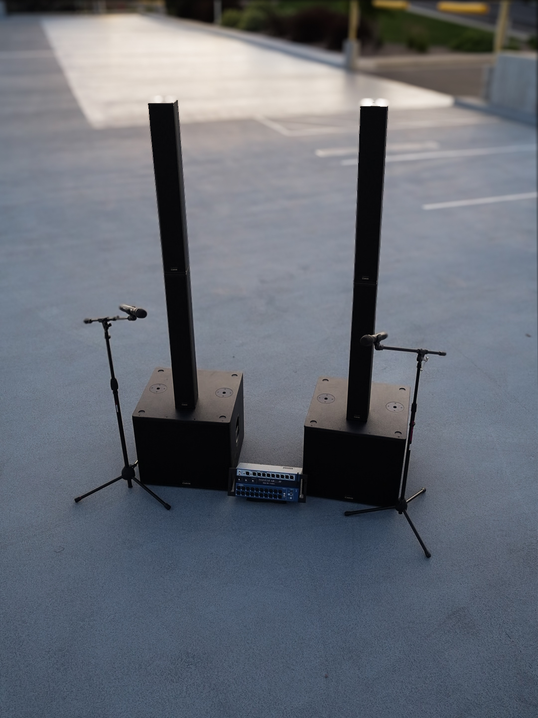 A complete event sound system staged outdoors at dusk