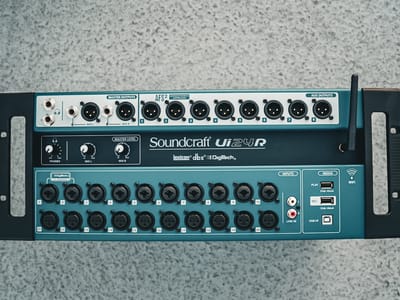 Close-up of a Soundcraft Ui24R digital mixer showing its twenty microphone inputs and eight aux outputs
