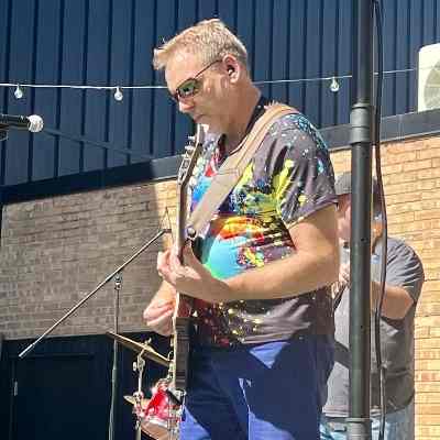 Gaylon Safer, owner of Utah Sound Systems, playing guitar at a live event